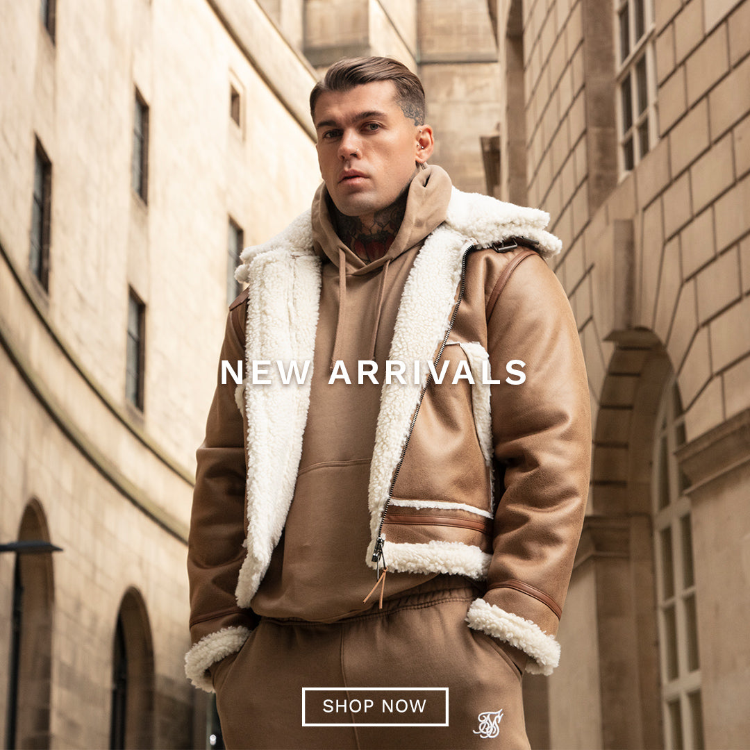 SikSilk New Arrivals. SikSilk model posing outside wearing new SikSilk Brown Aviator Jacket