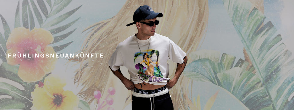 Spring Arrivals. SikSilk model posing in front of floral image, wearing new Ecru Graphic T-Shirt