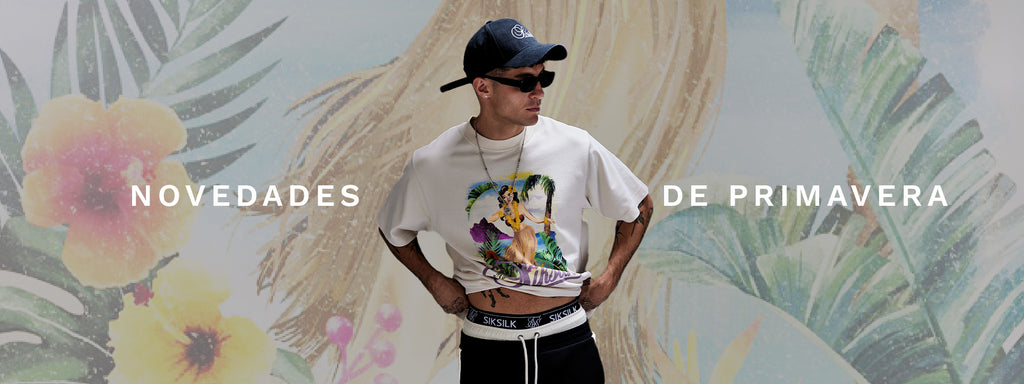 Spring Arrivals. SikSilk model posing in front of floral image, wearing new Ecru Graphic T-Shirt