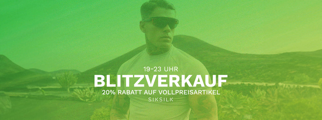 ST. PATRICKS DAY Sale, 20% Off Full Price Styles, 7 - 11pm. Image with a green flash over it. SikSilk model posing in Muscle Fit T-Shirt & shades outdoors in Lanzarote.