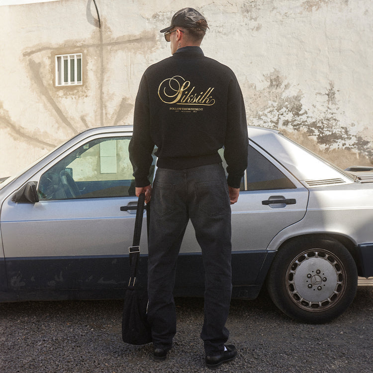 Autumn Vibes. Model posing in Black & Gold SikSilk Sweatshirt, in front of car